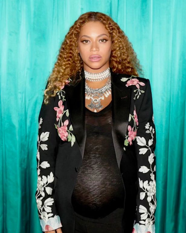 Beyonce cradles her huge bump as she poses up a storm in Gucci outfit for another impromptu photoshoot