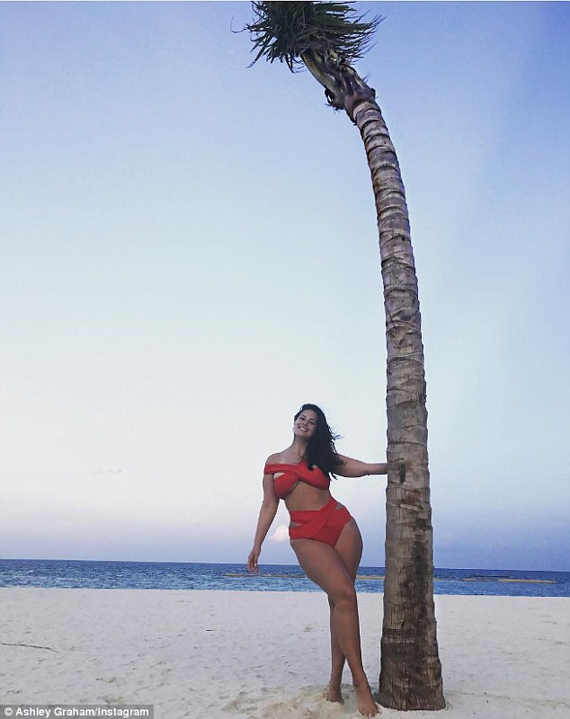 Ravishing in red! Ashley Graham flaunts her figure in a racy cut-out Bathing Suit