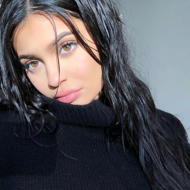 Kylie Jenner posts string of sultry selfies but keeps her ‘baby bump’ covered up under baggy jumper