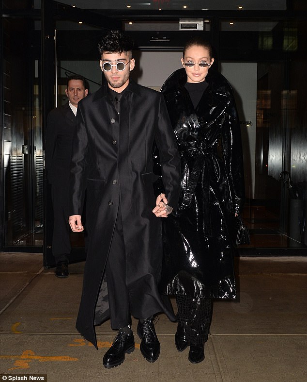 Gigi Hadid and Zayn Malik show off Futuristic Fashion sense in matching long black coats as they Celebrate Singer’s 25th Birthday